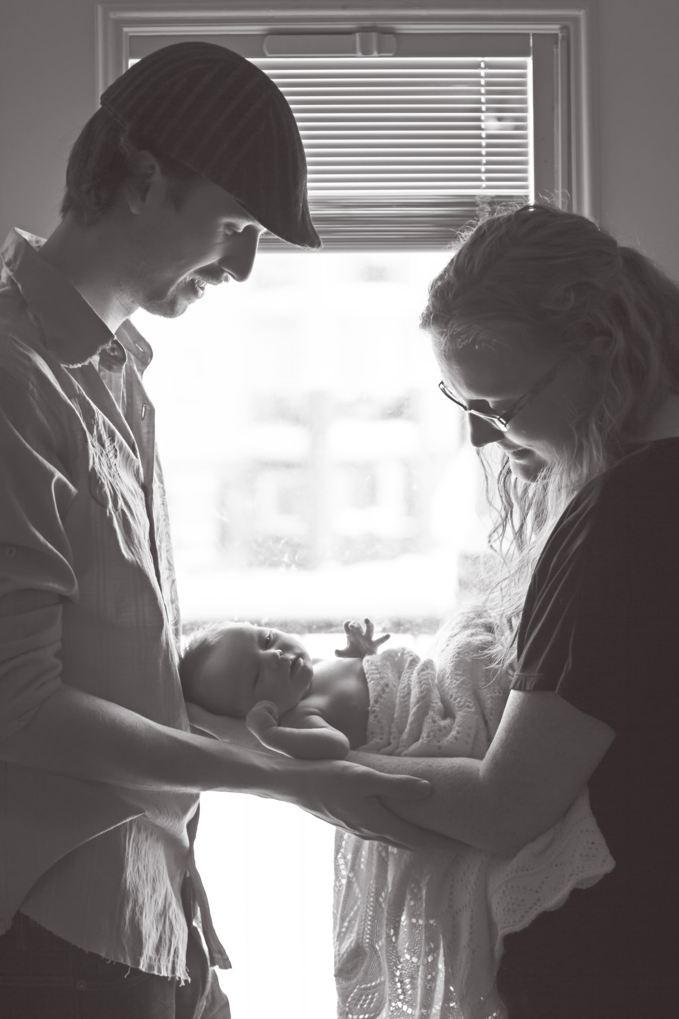 Parents holding their newborn together