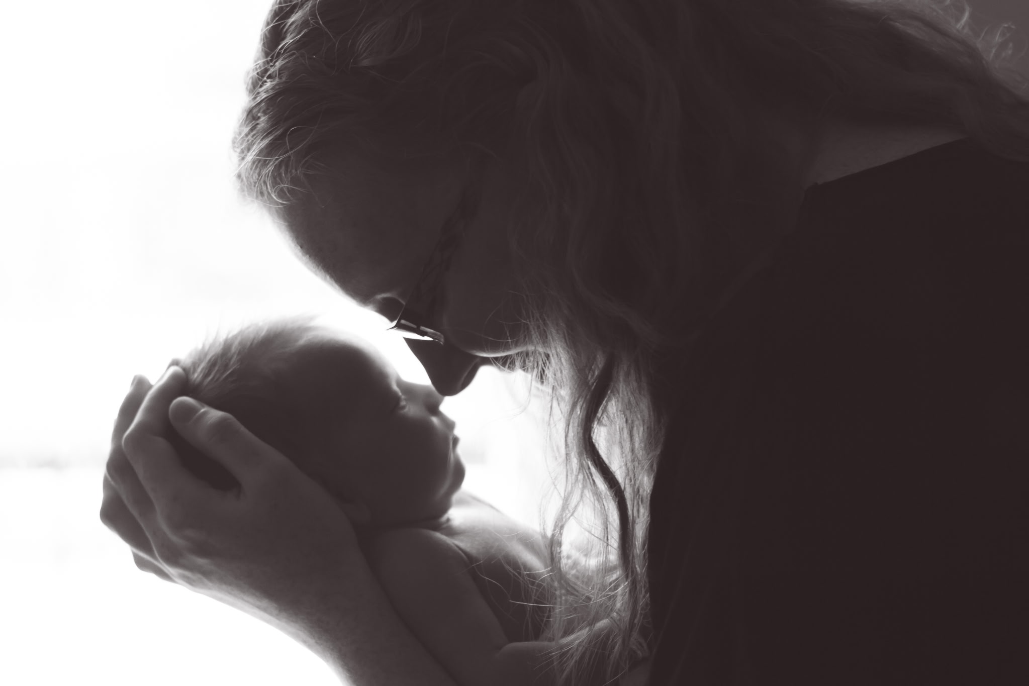 Mother holding her newborn close